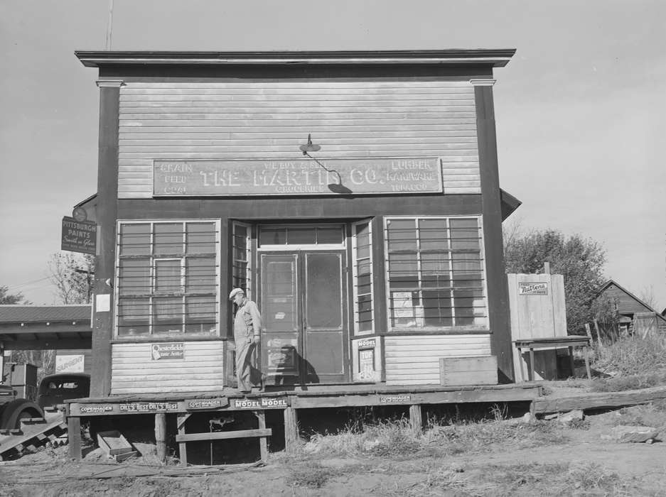 Main Streets & Town Squares, wooden building, history of Iowa, general store, Iowa History, Library of Congress, Businesses and Factories, wood sidewalk, man, Iowa, Cities and Towns, store front