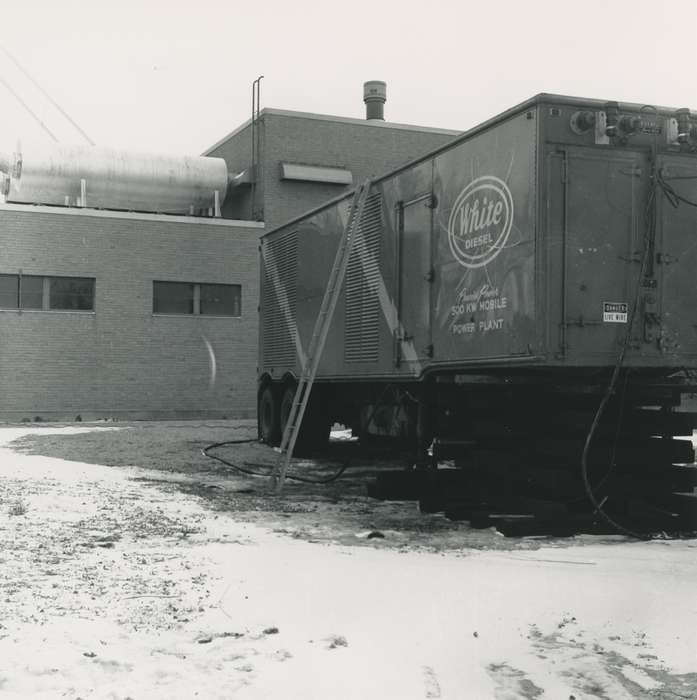 trailer, Iowa History, Waverly Public Library, Iowa, history of Iowa, Businesses and Factories, correct date needed, brick building, tire, electrical wires, Waverly, IA, ladder