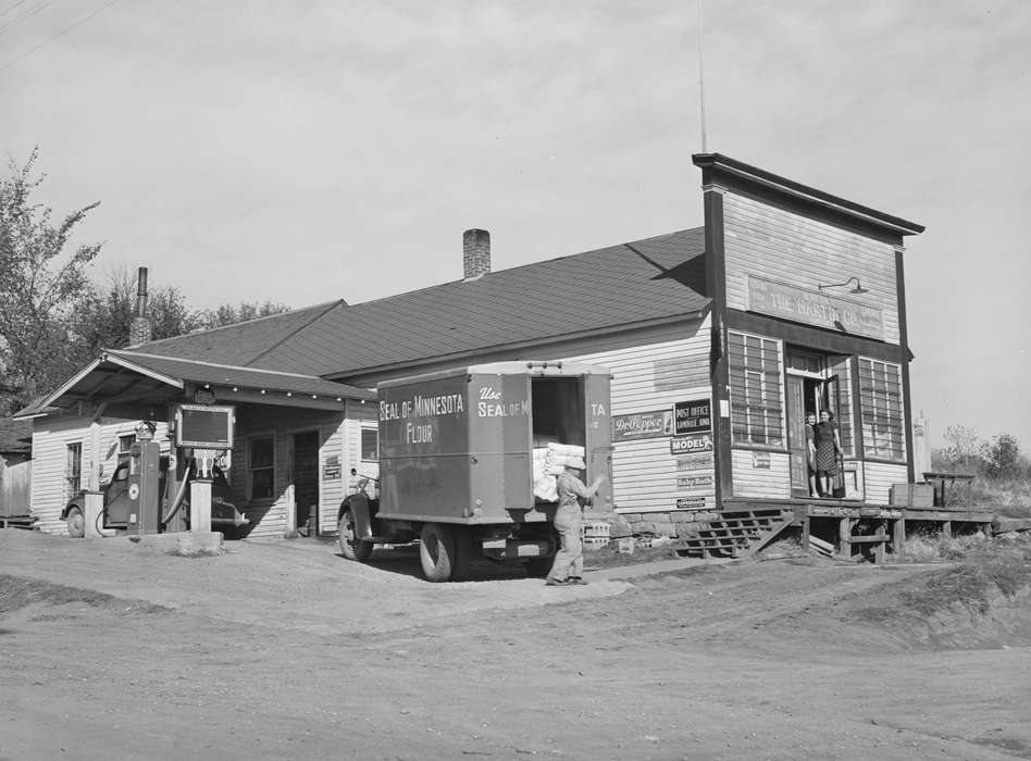 Main Streets & Town Squares, history of Iowa, Iowa History, general store, Library of Congress, Motorized Vehicles, Businesses and Factories, young women, gas station, Iowa, Cities and Towns, delivery truck, Labor and Occupations