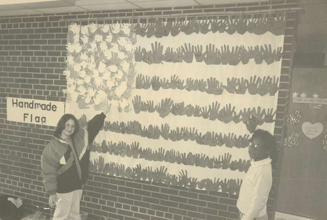 Portraits - Group, People of Color, Iowa History, history of Iowa, american flag, outfit, Waverly, IA, Iowa, brick wall, Schools and Education, sign, Children, Waverly Public Library, hand