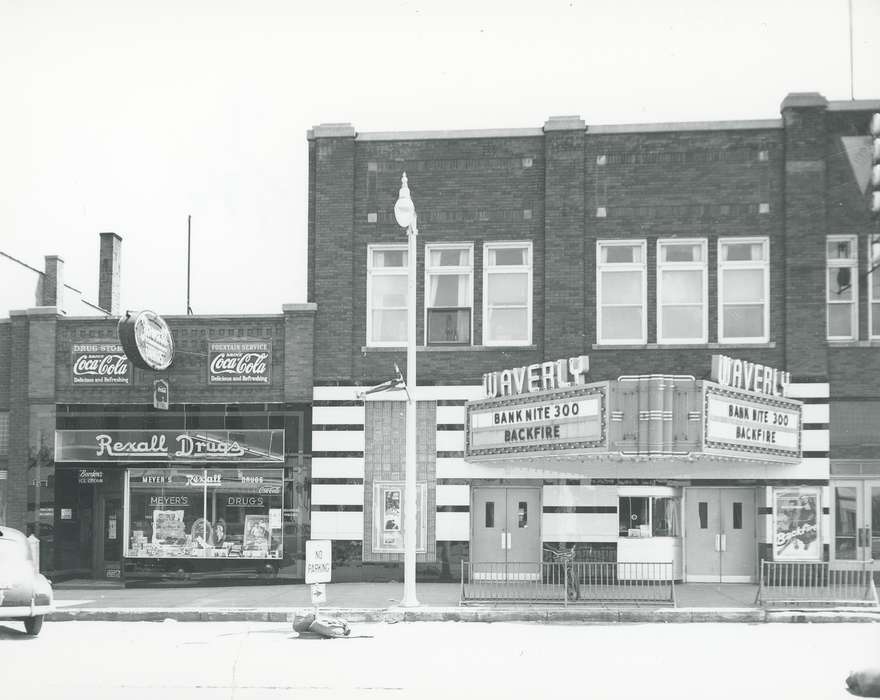 Waverly, IA, brick building, Main Streets & Town Squares, window, Iowa, Cities and Towns, Businesses and Factories, building, door, movie theater, history of Iowa, window display, coke sign, bicycle, pharmacy, poster, sign, Waverly Public Library, bike, Iowa History, street sign