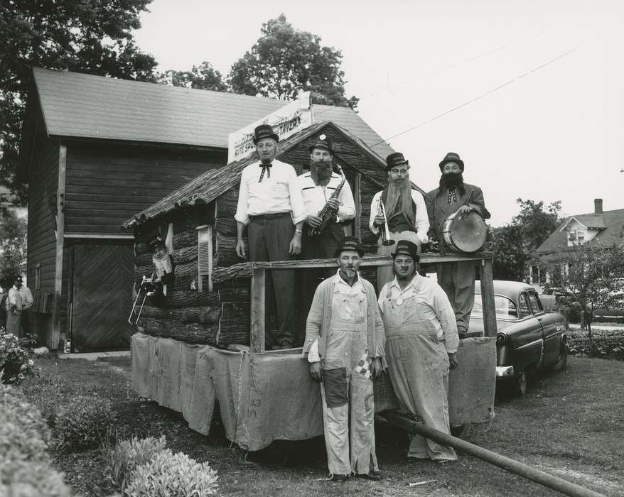 history of Iowa, Entertainment, Waverly Public Library, overalls, cigar, Iowa, log cabin, washboard, parade float, trumpet, drum, Iowa History, glasses, moustache, saxophone, bow tie, trombone, beard, top hat, Portraits - Group, Fairs and Festivals