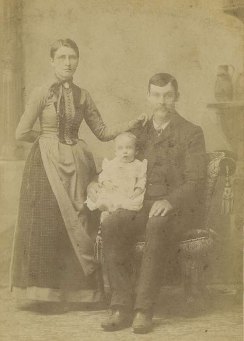 Portraits - Group, woman, cabinet photo, Iowa History, family, painted backdrop, brooch, Mason City, IA, baby, history of Iowa, man, Iowa, floor cloth, Olsson, Ann and Jons, couple, Families, buttons, chair